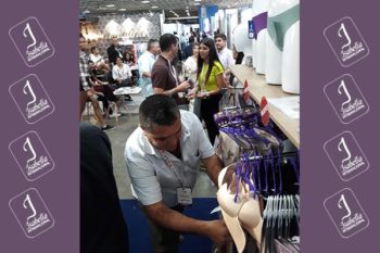 Top view of woman's black bra on the unmade bed