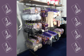 Top view of woman's black bra on the unmade bed