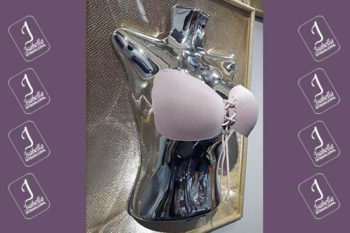 Top view of woman's black bra on the unmade bed