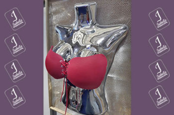 Top view of woman's black bra on the unmade bed