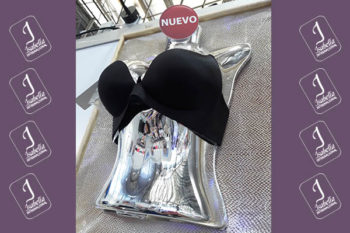 Top view of woman's black bra on the unmade bed