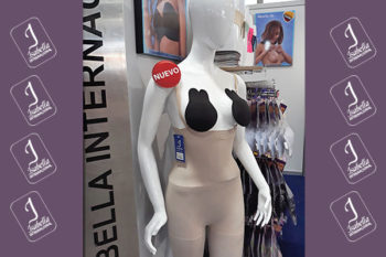 Top view of woman's black bra on the unmade bed