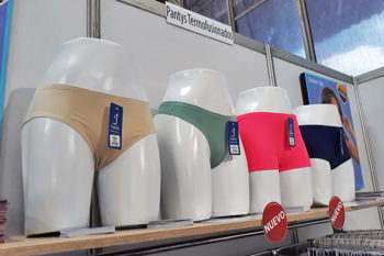 Top view of woman's black bra on the unmade bed