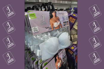 Top view of woman's black bra on the unmade bed