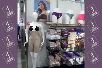 Top view of woman's black bra on the unmade bed