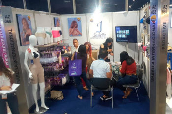 Top view of woman's black bra on the unmade bed