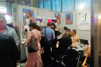 Top view of woman's black bra on the unmade bed