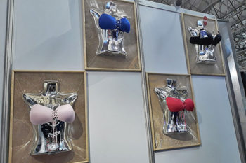 Top view of woman's black bra on the unmade bed