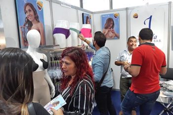 Top view of woman's black bra on the unmade bed